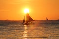 Sailing boats at sundowning with an orange sky and warm sunlight Royalty Free Stock Photo