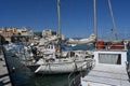 Sailing boats and yachts with white hulls in Greek port of Heraklion near the city center during summer.