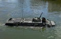 Sailing on BTR APC Amphibious Armoured Personnel Carrier. Armed forces on military exercises in river. Military equipment and