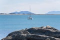 Sailing Catamaran At Anchor Offshore From Beach