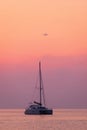 Sailing catamaran on a background of beautiful sunrise in the ocean Royalty Free Stock Photo