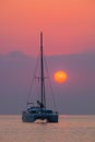 Sailing catamaran on a background of beautiful sunrise in the ocean Royalty Free Stock Photo