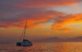 Sailing catamaran at the ocean at the coast of South Africa at sunrise.