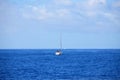 Sailing catamaran with open sails. Sailing catamaran in the middle of the sea in a tropical landscape Royalty Free Stock Photo
