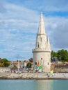 Sailing dinghies at the dock ready to sail with a tower in the background in La Rochelle