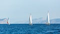 Sailing luxury boats participate in yacht regatta in the Aegean Sea.