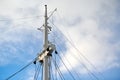 Sailing mast of ship on blue cloudy sky background Royalty Free Stock Photo