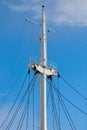 Sailing mast of ship on blue cloudy sky background Royalty Free Stock Photo