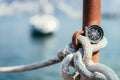 Sailing: nautical compass on a sailing rope, pier. Sailing boats in the background