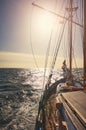 Sailing old schooner at orange sunset Royalty Free Stock Photo