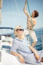 Young caucasian attractive couple navigating a yacht in caribbean sea Royalty Free Stock Photo