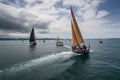 sailing race, with boats speeding across the water and crew members busy at work