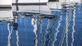 Sailing. Reflection of yacht masts in the water of the Harbor.