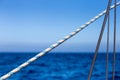 Sailing Ropes in Front of bight blue Ocean and Sky Background Royalty Free Stock Photo