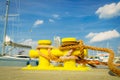 Sailing ropes tied around yellow marina bollard Royalty Free Stock Photo