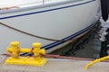 Sailing ropes tied around yellow marina bollard Royalty Free Stock Photo