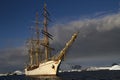 Sailing ship on the background of the mountains of the Antarctic Royalty Free Stock Photo