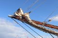 Sailing ship mast against the blue sky on some sailing boats with rigging details