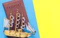 Sailing ship model on blue yellow for travel concept post Royalty Free Stock Photo