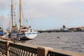 Sailing ship on the Neva river in Saint Petersburg on a Sunny day, the dome of St. Isaac`s Cathedral on the horizon Royalty Free Stock Photo