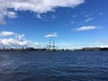 Sailing ship Poltava and warships in the Neva river. Preparation for the naval parade in St. Petersburg against the background of Royalty Free Stock Photo