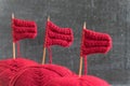 Sailing ships made from red yarn and knitting needles
