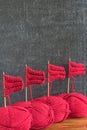 Sailing ships made from red yarn and knitting needles