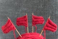 Sailing ships made from red yarn and knitting needles