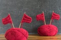 Sailing ships made from red yarn and knitting needles