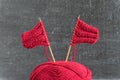 Sailing ships made from red yarn and knitting needles