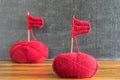 Sailing ships made from red yarn and knitting needles