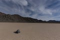 Sailing Stone with sky obscured by clouds and mountains Royalty Free Stock Photo