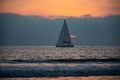 Sailing in the sunrise time with sailboat. Sunrise over the sea and beautiful cloudscape. Colorful ocean beach sunset. Royalty Free Stock Photo