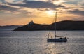 Sailing at sunset, Mediterranean sea. Lighthouse at Kea island, Greece Royalty Free Stock Photo