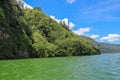 Sailing a traditional fishing boat from the village of Trunyan to a unique cemetery. High mountains covered with dense tropical Royalty Free Stock Photo