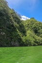 Sailing a traditional fishing boat from the village of Trunyan to a unique cemetery. High mountains covered with dense tropical Royalty Free Stock Photo