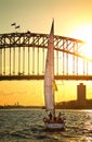 Sailing under Sydney Harbour Bridge at sunset Royalty Free Stock Photo