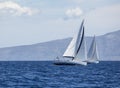 Sailing in the wind through the waves at the Aegean Sea in Greece. Luxury yachts. Royalty Free Stock Photo