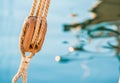 Sailing, wooden pulley with nautical ropes and blue sea water