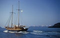 Sailing wooden ship yacht sailing in caldera on volcanic island of Santorini