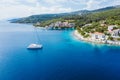 Sailing yacht boat in blue sea arrive Fiscardo village in Kefalonia island, Greece Royalty Free Stock Photo