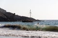 A sailing yacht or boat in the horizon of seascape in summer in sunset Royalty Free Stock Photo