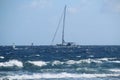 Sailing yacht on choppy sea glistening in the sun with windsurfers around, Tenerife, Spain Royalty Free Stock Photo