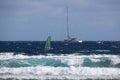 Sailing yacht on choppy sea glistening in the sun with windsurfers around, Tenerife, Spain Royalty Free Stock Photo