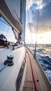 Sailing yacht cruising on the open sea, dramatic sky and sunlight, angle on deck and mast. Royalty Free Stock Photo
