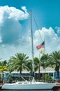 Sailing yacht at dock side, in a tropical harbor, flying American flag Royalty Free Stock Photo