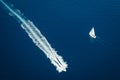 Sailing yacht and fast motorboat from above