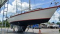 Sailing yacht on hardstand in Phuket boat lagoon marina for antifouling