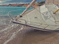 Sailing yacht lying on the beach Royalty Free Stock Photo