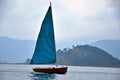 Sailing yacht and mountains in foggy weather